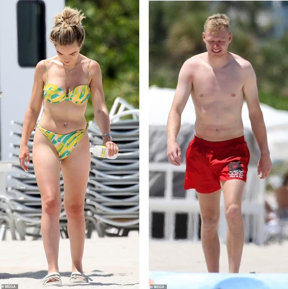 Thủ môn Arsenal mặc quần đùi đỏ khoe vóc dáng cao lớn 1m88. Trong khi đó, bạn gái anh diện bikini màu vàng-xanh để lộ thân hình nuột nà, gợi cảm.