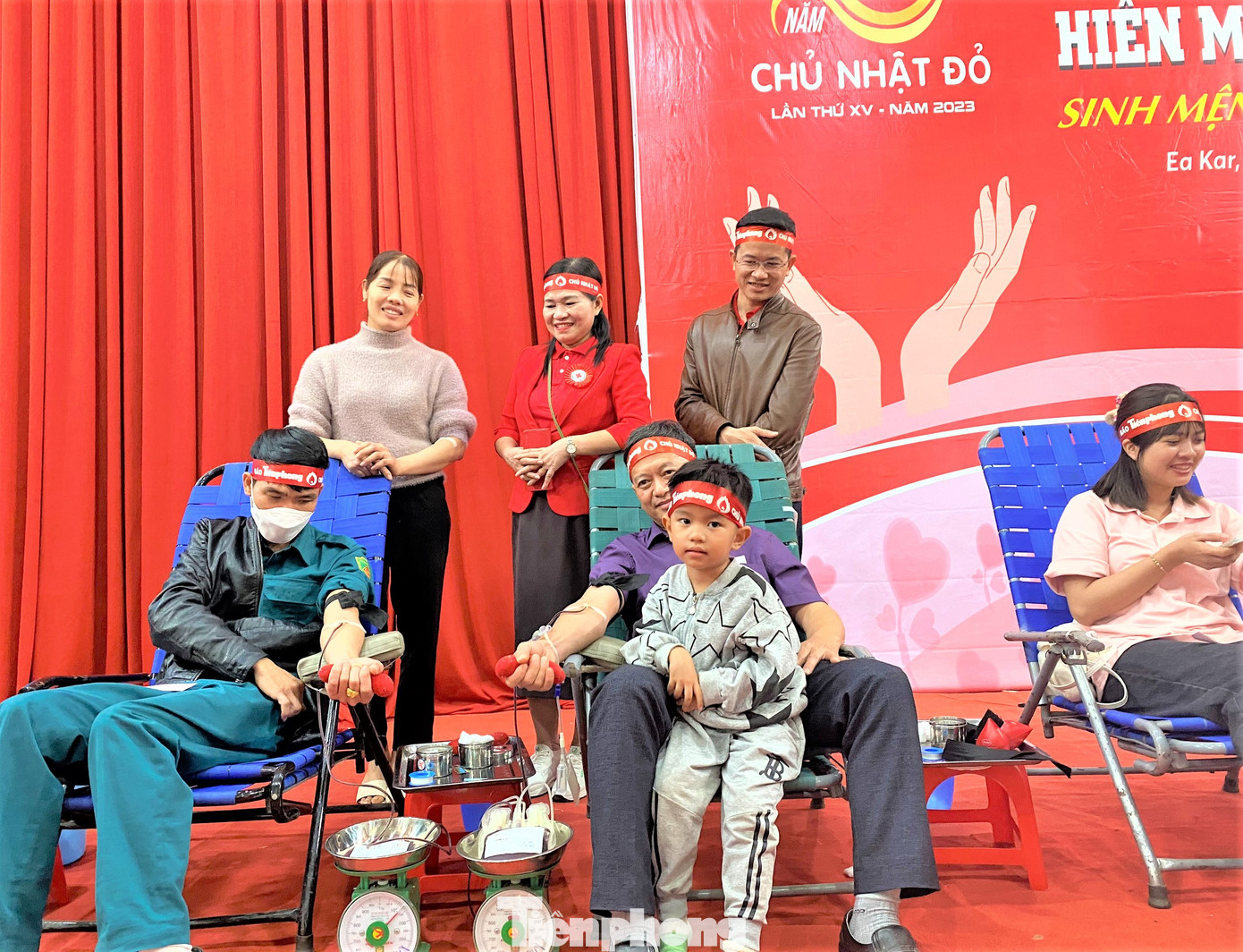 Một tình nguyện viên đưa con cùng tham gia chương trình Chủ nhật đỏ