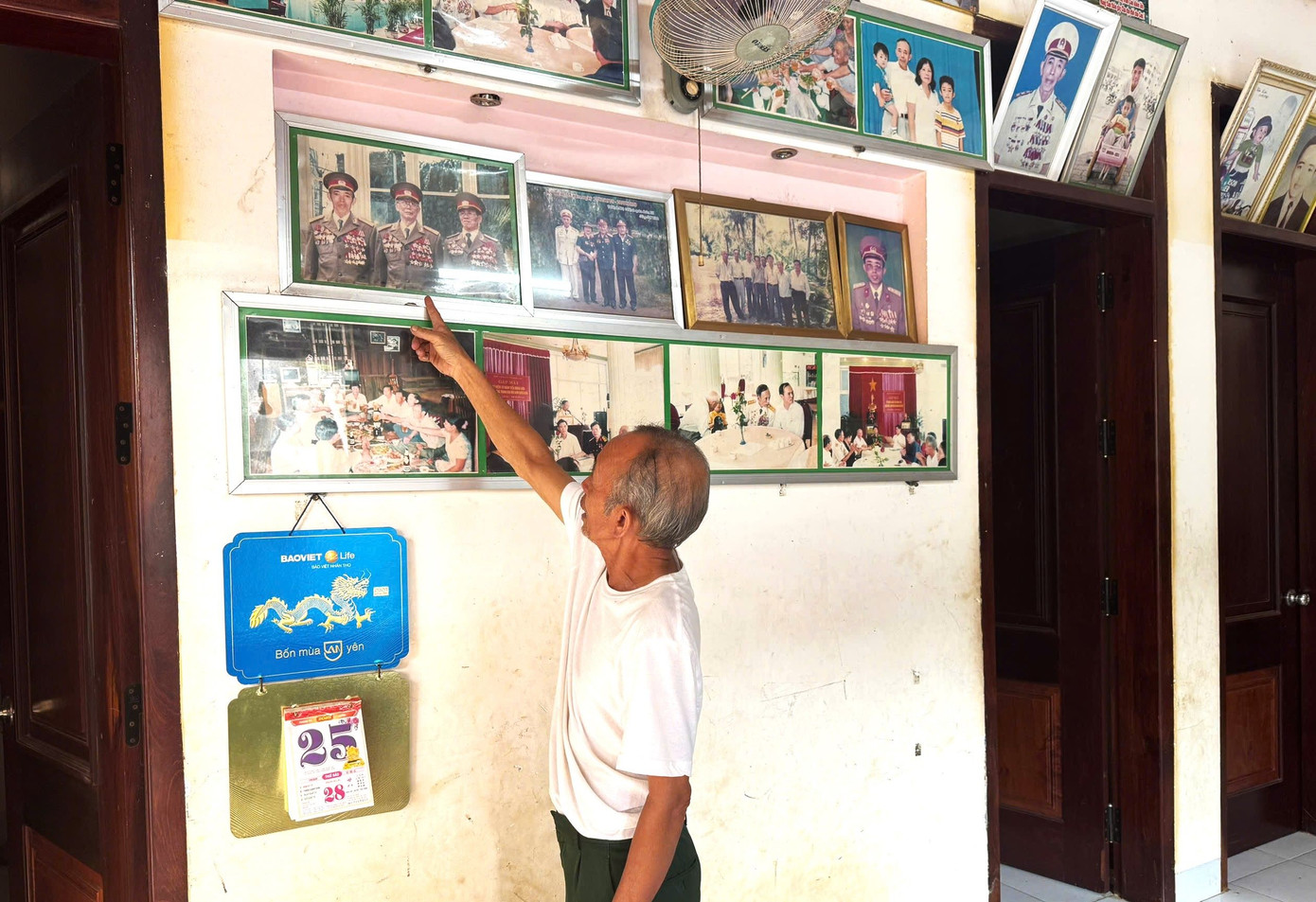 Cựu binh Nguyễn Văn Tính bên những tấm ảnh chụp cùng đồng đội.