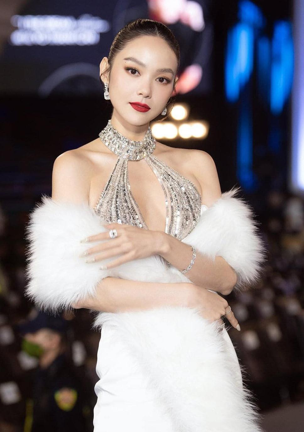 Cách làm tóc và trang điểm của Minh Hằng khá giống với Đỗ Mỹ Linh, tuy nhiên nữ ca sĩ tạo điểm nhấn bằng loạt trang sức kim cương đắt đỏ.