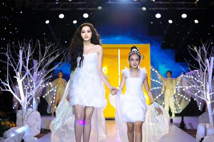 Đỗ Thị Hà và người mẫu nhí mặc váy đôi khi catwalk trên sàn diễn.