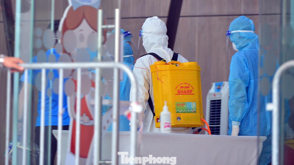 Lực lượng y tế quận Thanh Xuân tiến hành khử khuẩn khu vực sảnh toà nhà.