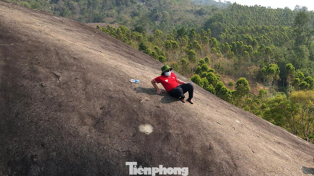 Du khách rón rén từng mét để di chuyển xuống dưới chân núi sau khi thăm quan, check-in trên lưng "Đá Voi Mẹ".
