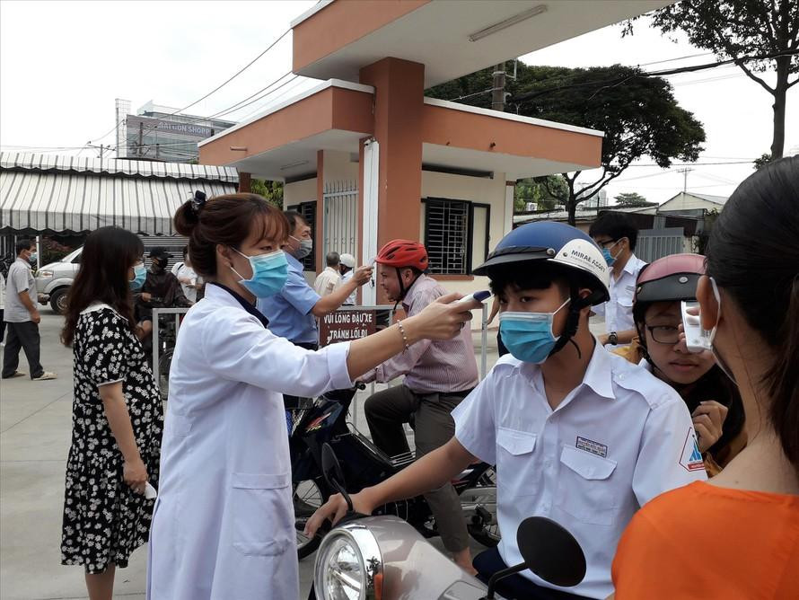 Trường THPT chuyên Nguyễn Hữu Huân đo thân nhiệt cho học sinh trước khi các em vào lớp Trường THPT chuyên Nguyễn Hữu Huân đo thân nhiệt cho học sinh trước khi các em vào lớp