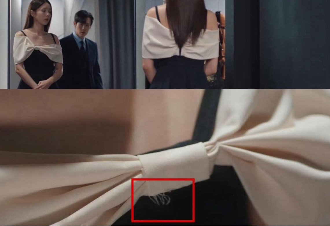 Máy quay chiếu cận đoạn chỉ thừa trên váy Hee Joo mặc. Máy quay chiếu cận đoạn chỉ thừa trên váy Hee Joo mặc.