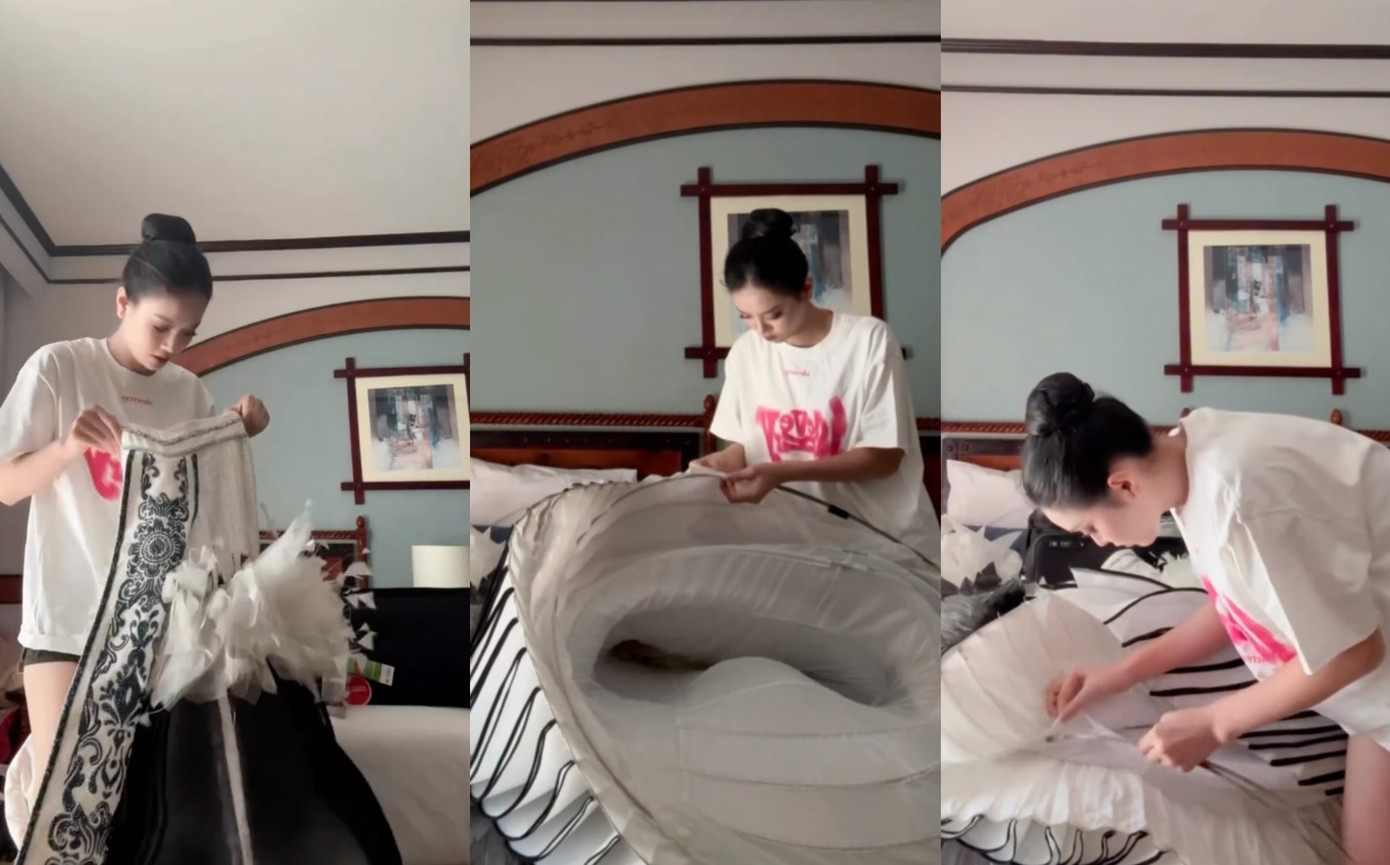 Bùi Khánh Linh tự tay chỉnh sửa trang phục trước khi thi.