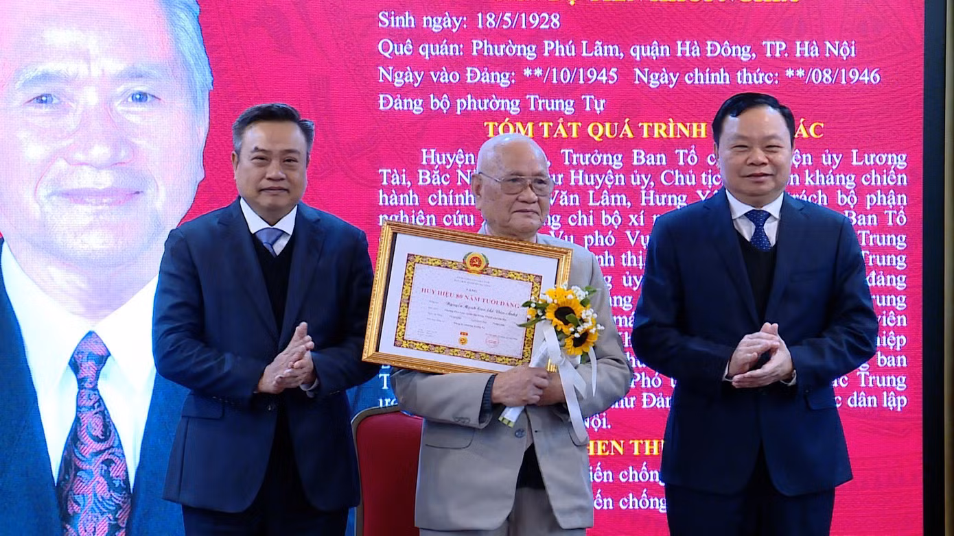 Chủ tịch Trần Sỹ Thanh (ngoài cùng bên trái) trao Huy hiệu 80 năm tuổi Đảng cho lão thành.