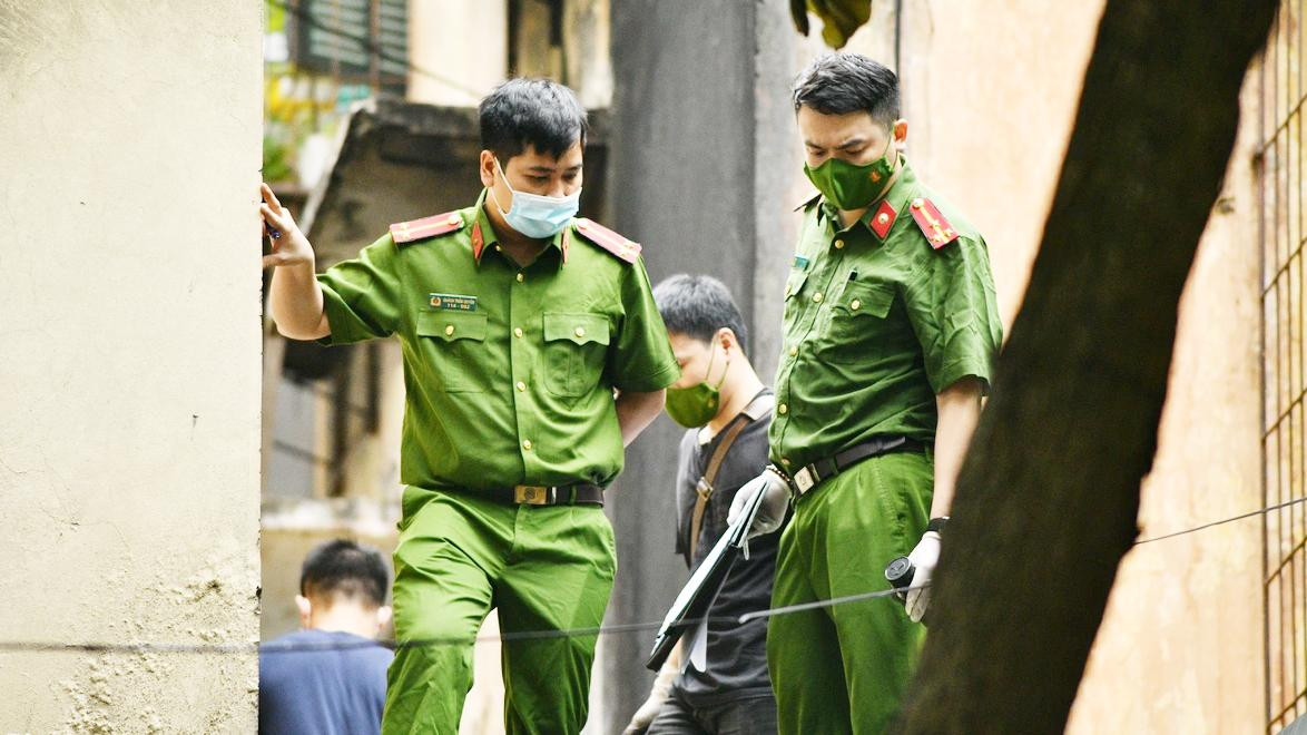 Cảnh sát khám nghiệm hiện trường vụ cháy có 5 người tử vong ở Hà Nội vào sáng 21/4. Ảnh: Thạch Thảo.