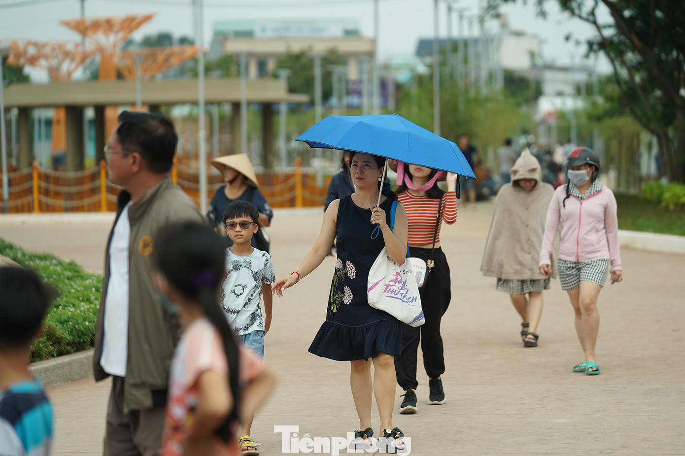 Thời tiết TPHCM những ngày qua có nền nhiệt khá cao, công viên chưa đủ cây xanh để phủ bóng mát nên du khách phải tự chuẩn bị các vật dụng chống nắng.