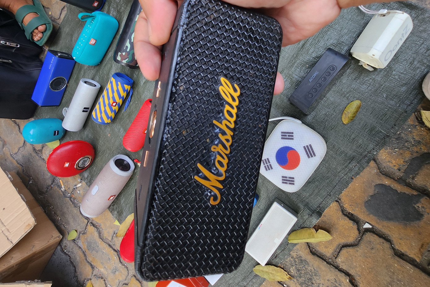 Tại chợ đồ cũ Nhật Tảo, khách có thể tìm thấy những món đồ độc đáo, có giá trị cả về mặt lịch sử và thầm mĩ. Trong ảnh, chiếc loa di động thương hiệu nổi tiếng được kêu giá 400 nghìn đồng và chốt bán ở mức 200.000 đồng. "Nói thiệt thấy thích thì mua, nghe thử cũng ổn và chỉ mất 200.000 đồng. Theo tôi thấy, mua với mức giá đó là người bán đã lời nhiều rồi. Mấy đồ cũ này mua lại rẻ lắm, nên ra đây trả kiểu nào cũng bán, quan trọng là người mua có mạnh miệng trả giá hay không thôi", anh Phong, người vừa mua chiếc loa nói.