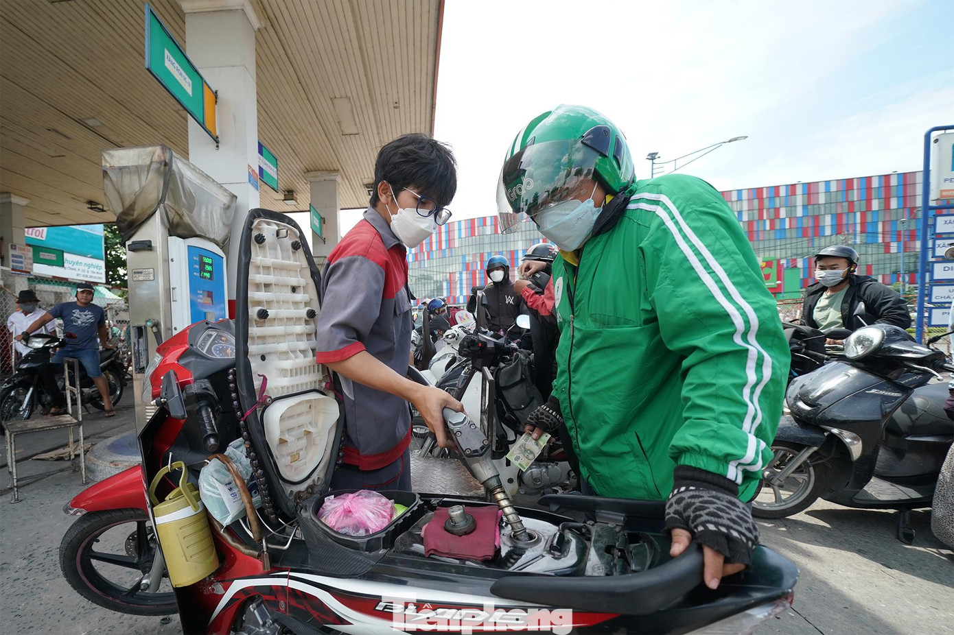 Một bác tài xe ôm công nghệ vui mừng khi được đổ đầy bình. Một bác tài xe ôm công nghệ vui mừng khi được đổ đầy bình.
