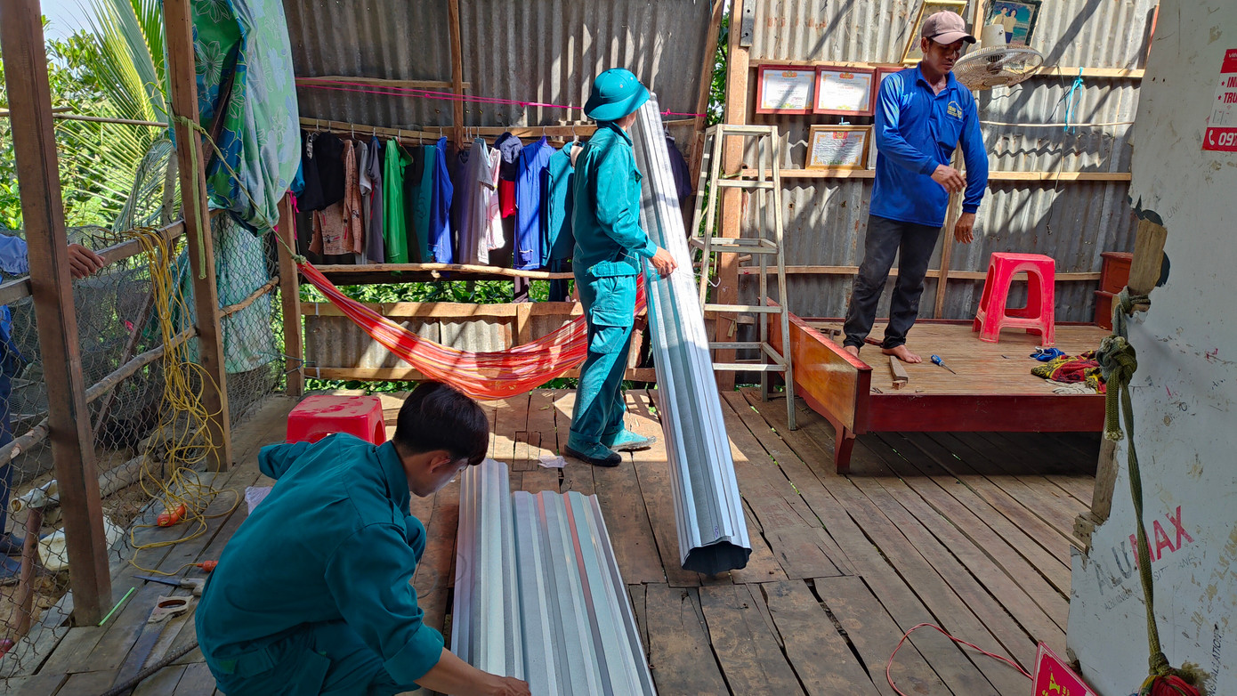 Lực lượng dân quân đến hỗ trợ người dân khắc phục, sửa chữa. Ảnh: Duy Phước