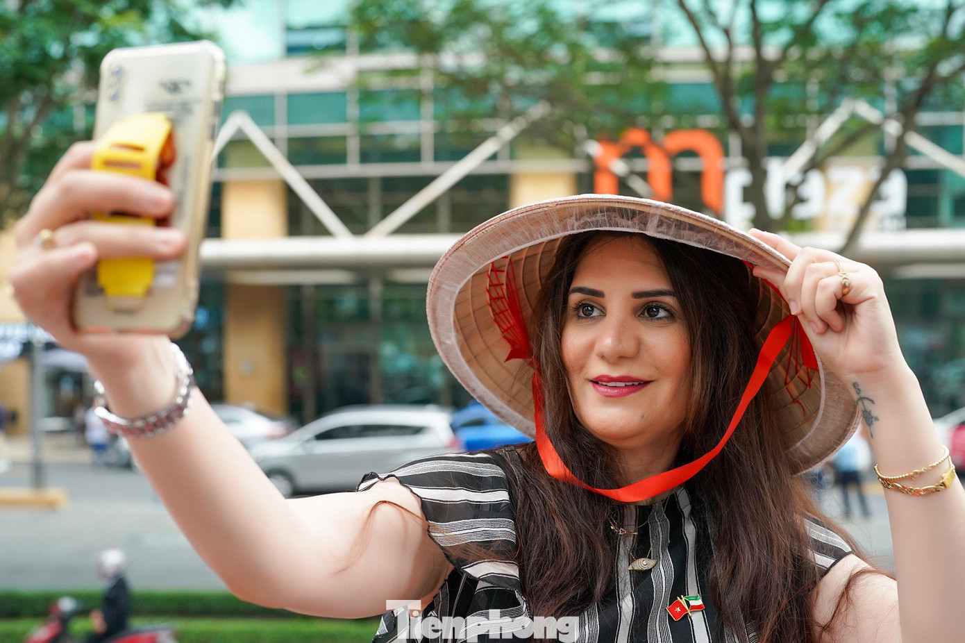 Một đại diện đến từ Brazil tạo dáng với chiếc điện thoại của mình lưu lại hình ảnh một TPHCM hồi sinh mạnh mẽ sau đại dịch COVID-19 .