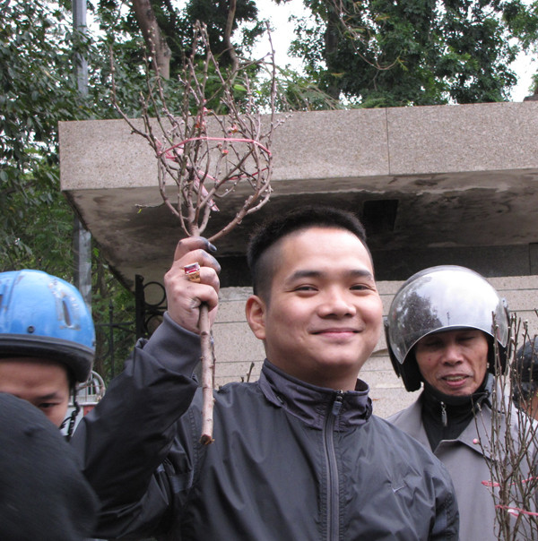 Cầm cành đào nhỏ xíu trên tay, nam thanh niên trong ảnh bất ngờ với mức giá 60.000 đồng