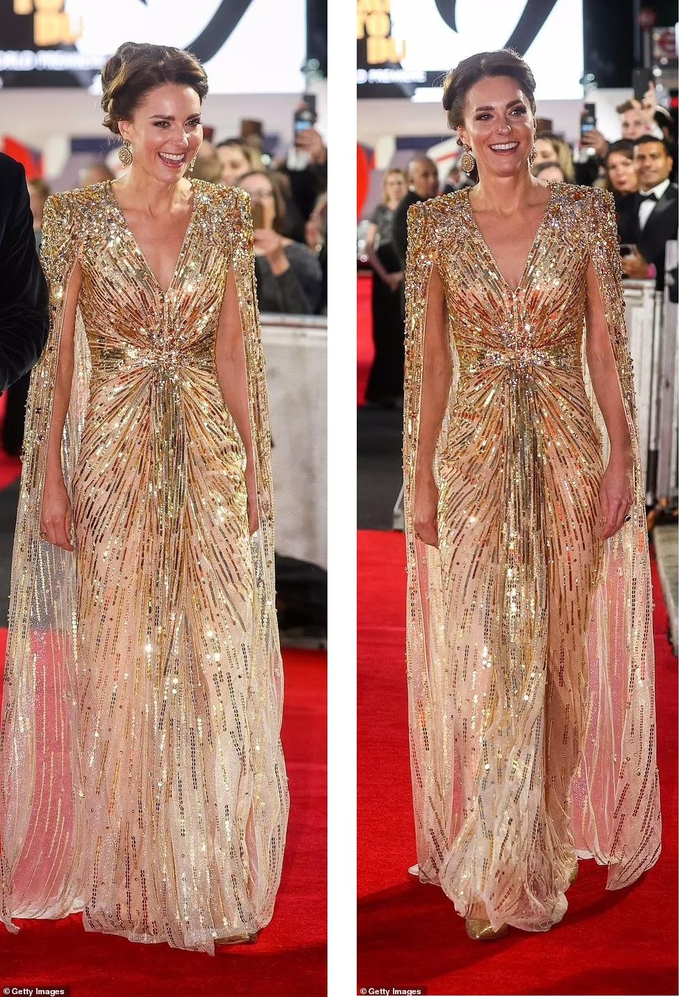 Chiếc váy dáng cape (áo choàng) ánh kim xuyên thấu nhẹ nhàng với thiết kế đính kết cầu kỳ ở phần vai. Đường cắt cổ chữ V tinh tế đủ gợi cảm mà không hề hở quá đà. Bên cạnh đó, chi tiết nhún ở eo tôn lên vòng hai thon gọn của Công nương Kate dù đã ba lần sinh nở.