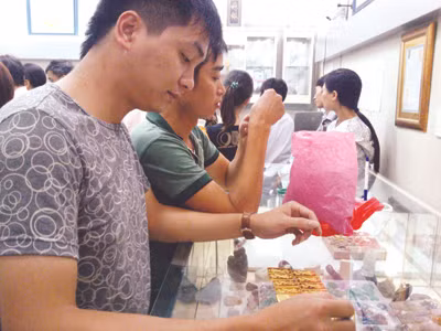 Ngân hàng thu phí gửi vàng khiến nhu cầu mua vàng tích trữ của người dân giảm (trong ảnh: Dân đến chi nhánh SJC miền Bắc mua vàng). Ảnh: Ngọc Mai