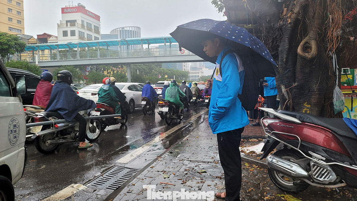 Sinh viên mòn mỏi đứng chờ xe buýt đến trễ do đường tắc.