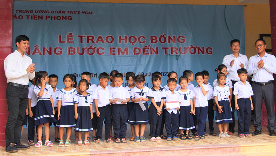 Nhà báo Lý Thành Tâm - Trưởng ban Đại diện Báo Tiền Phong tại TPHCM, nhà báo Trần Ngọc Lâm – Phó ban Đại diện Báo Tiền Phong tại TPHCM và đơn vị tài trợ trao học bổng cho học sinh.