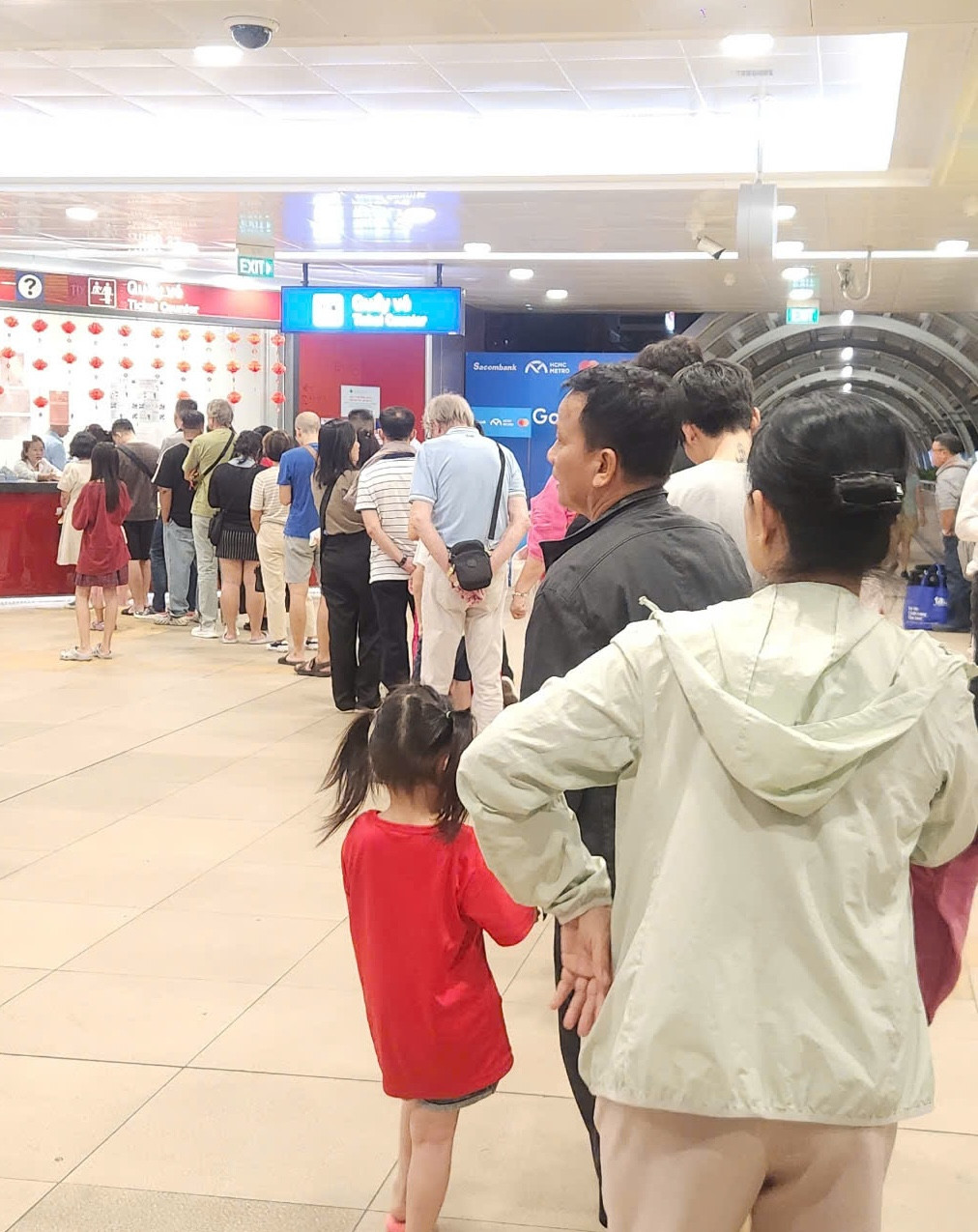 Khách xếp hàng mua vé lên tàu thuộc metro số 1