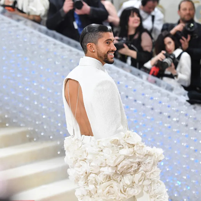 Bad Bunny diện nguyên set đồ trắng kem với chất liệu vải tweet, đi kèm với khăn choàng dài. Bad Bunny diện nguyên set đồ trắng kem với chất liệu vải tweet, đi kèm với khăn choàng dài.