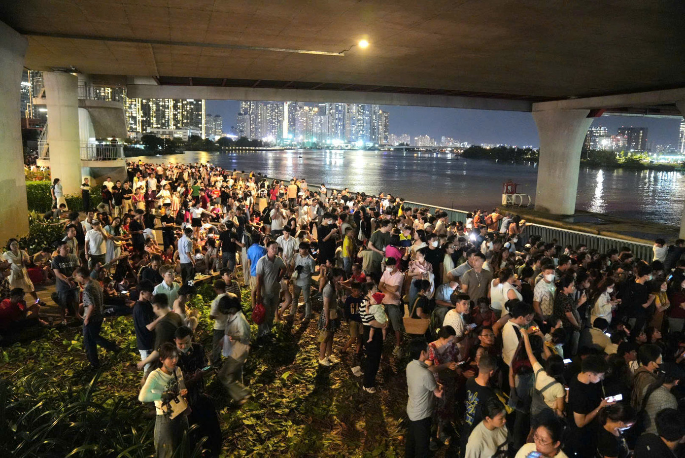 Nhiều người dân ra các vị trí 'đẹp' và thoáng từ chiều để chờ đợi màn bắn pháo hoa. Ảnh: Hiếu Duy