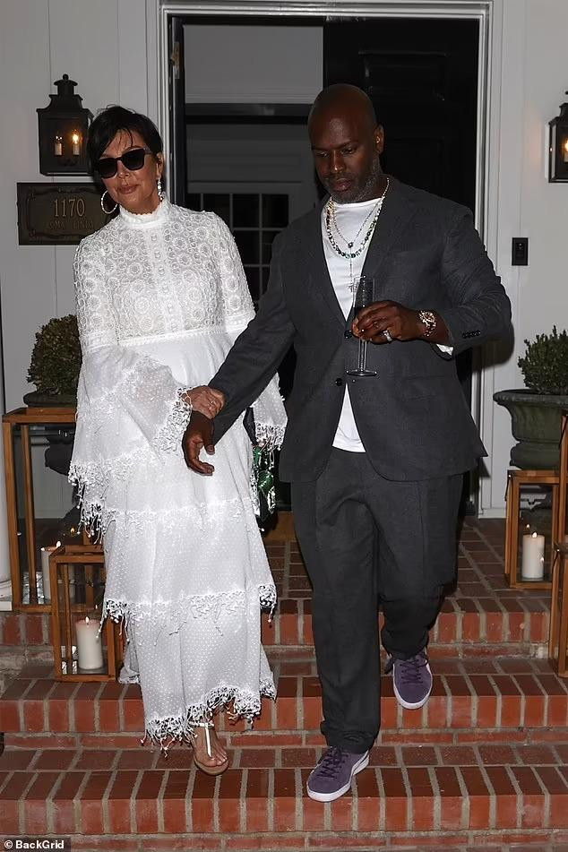 Bà Kris Jenner sang trọng với váy đầm ren trắng. Bà sánh đôi với bạn trai kém 25 tuổi Corey Gamble. Kendall là người tổ chức bữa tiệc nhưng lại vắng mặt.