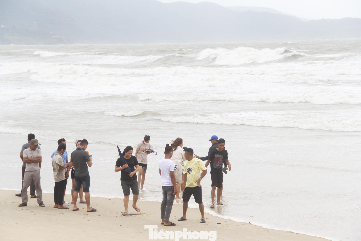 Nhiều nhóm bạn xuống sát mép nước để chụp hình lưu niệm, trò chuyện. Được biết, sau bão Noru, Đà Nẵng vẫn chưa gỡ bỏ lệnh cấm tắm biển.