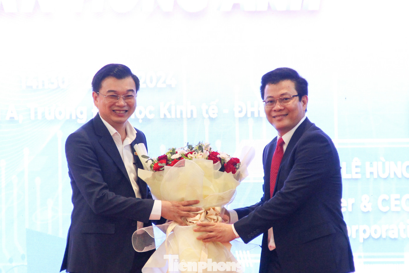 Đại diện trường ĐH Kinh tế - ĐH Đà Nẵng tặng hoa cho Shark Lê Hùng Anh. Ảnh: Giang Thanh