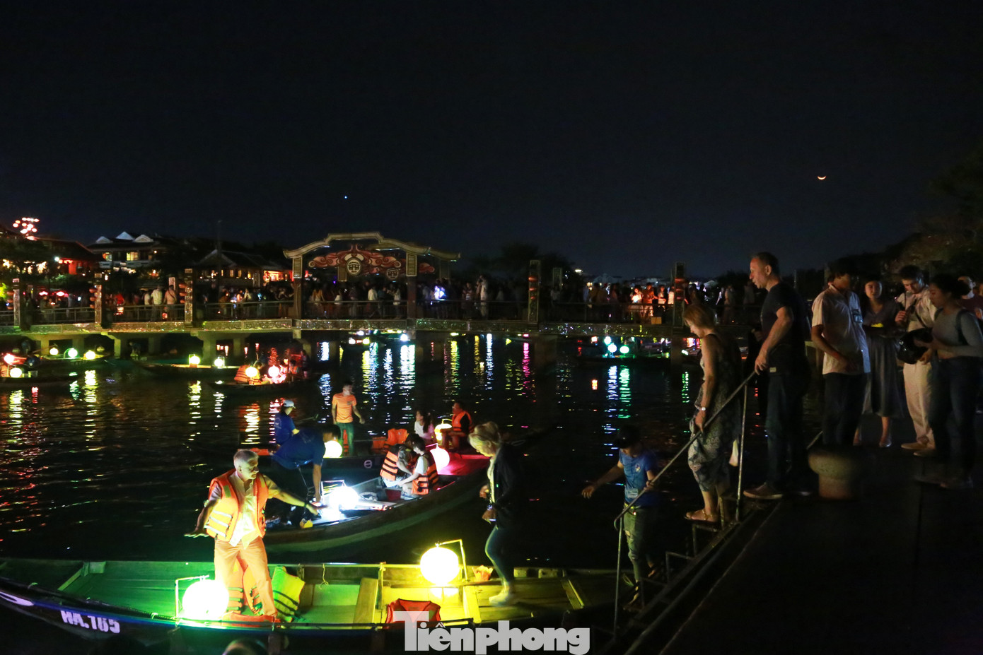 Cầu An Hội bắc qua sông Hoài vốn lung linh về đêm với ánh đèn led đủ sắc màu nay chỉ được soi rọi bởi ánh trăng, ánh sáng từ những chiếc đèn lồng ở dưới thuyền hắt lên.