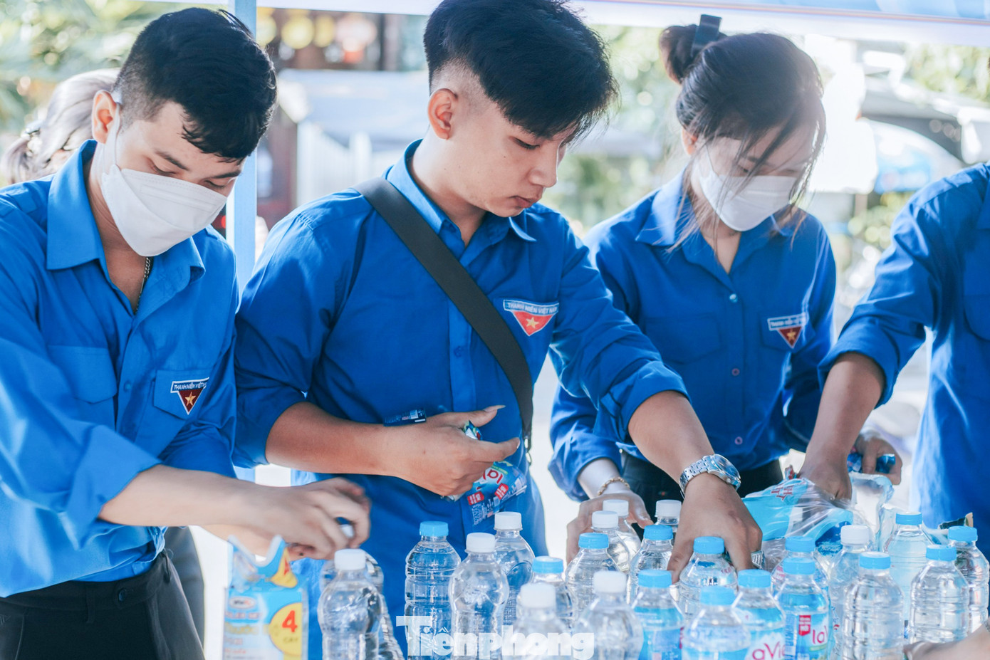 Để sĩ tử có thể mang nước vào phòng thi, các tình nguyện viên cẩn thận bóc bỏ tem chai nước, những phần có chữ viết không phù hợp với nội quy phòng thi.