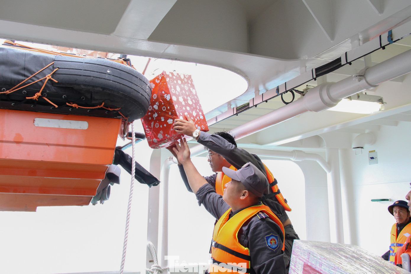 Các chiến sĩ Vùng 3 Hải quân "vật lộn" với sóng dữ trong hơn 2 tiếng đồng hồ để chuyển hàng lên tàu cá. Những phần quà sẽ được các cán bộ, chiến sĩ của Trạm ra đa 540 (Trung đoàn 351, Vùng 3 Hải quân) tiếp nhận.