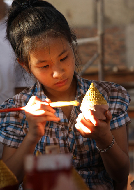 Sơn màu cho tsa tsa. Trên mỗi tsa tsa lại có hình của 108 bảo tháp bé xíu