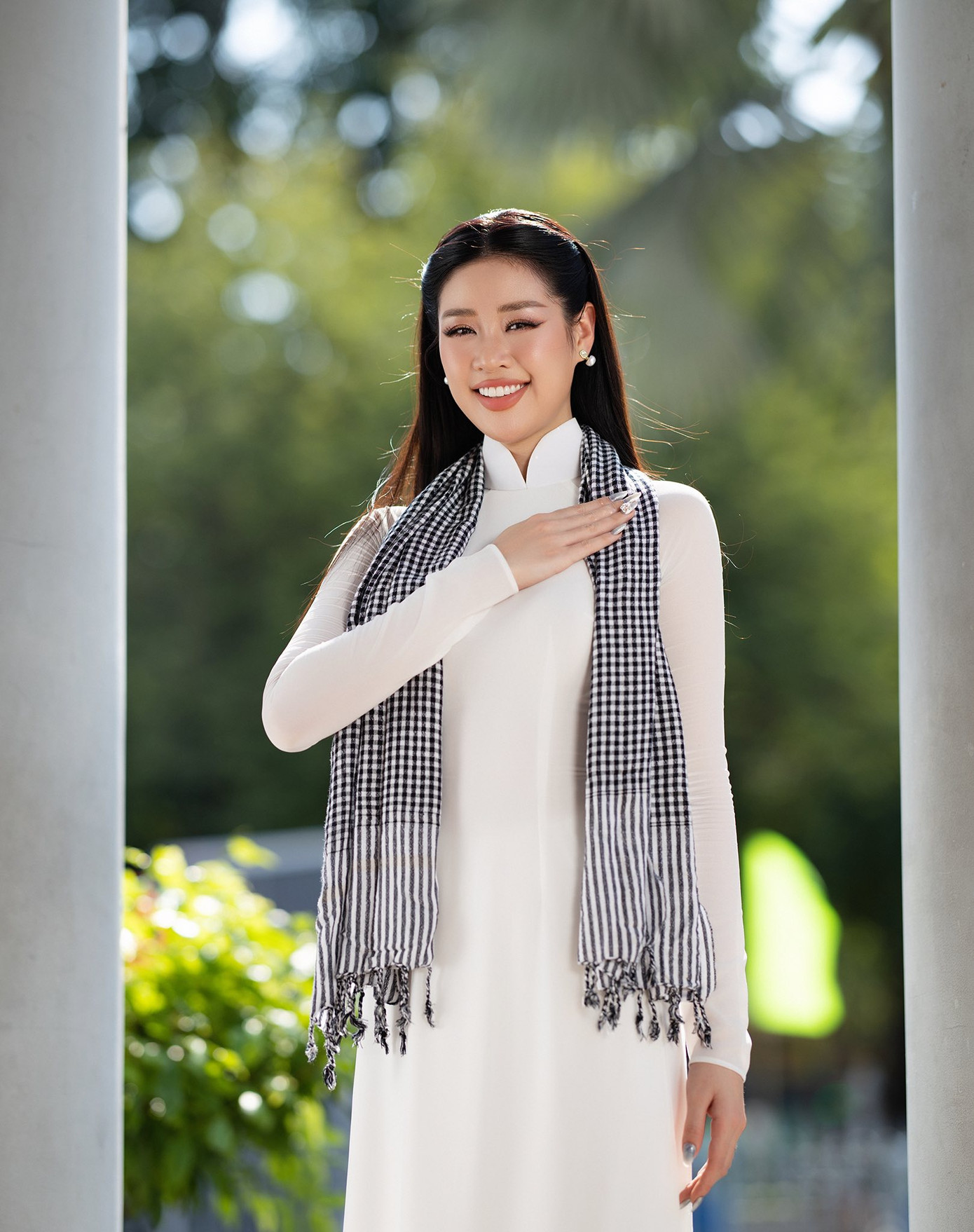 "50 năm - một chặng đường lịch sử đáng tự hào", Khánh Vân chia sẻ. Cô được chồng chụp bộ ảnh mặc áo dài trắng, đeo khăn rằn khi đến thăm nhiều di tích lịch sử ở TPHCM.