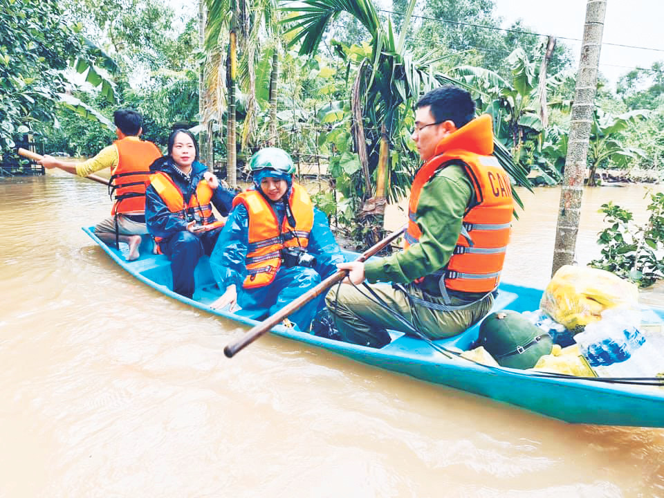 Lực lượng công an hỗ trợ phóng viên tác nghiệp trong mưa lũ Hà Tĩnh. Ảnh: Hoài Nam