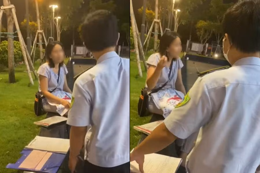 Người phụ nữ cãi cùn khi bị lực lượng chức năng nhắc nhở vì không đeo khẩu trang, ngồi ở công viên khâu vá. (Ảnh cắt từ clip)