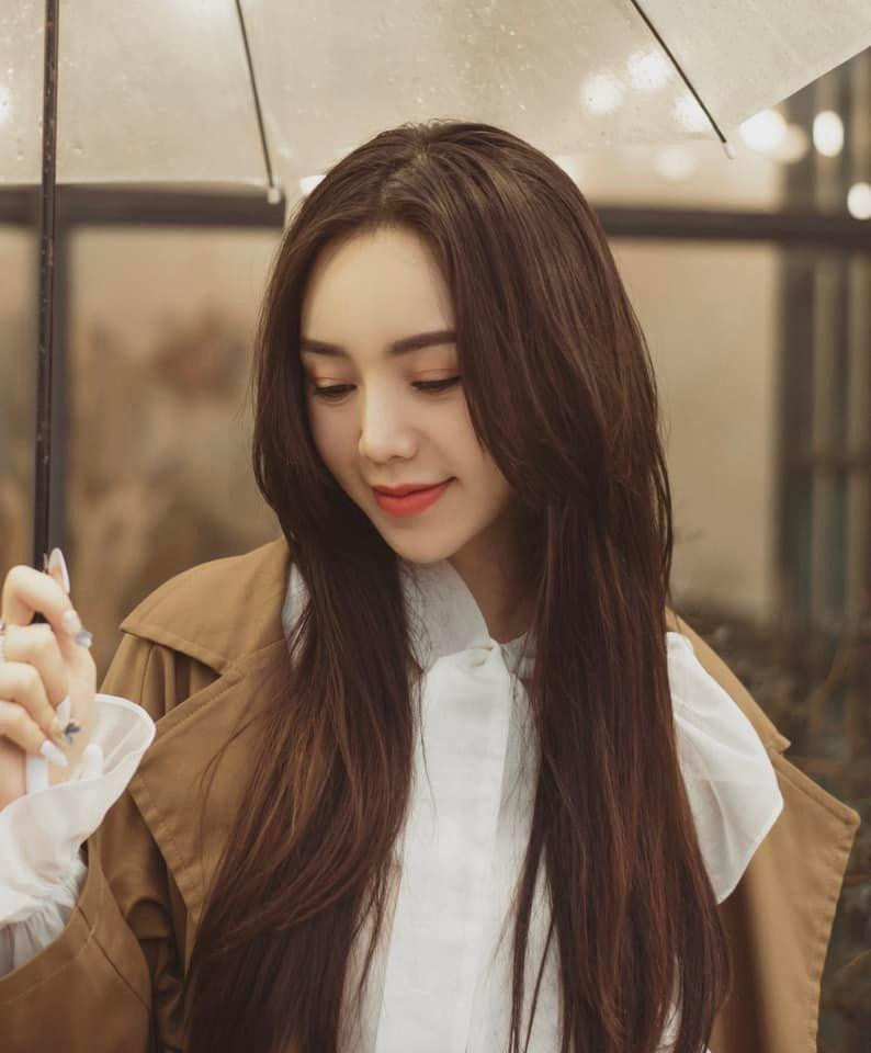 Diện áo sơ mi trắng cổ cao với phần bèo to công chúa kết hợp cùng áo măng tô, Quỳnh Kool hóa nàng thơ xinh đẹp.