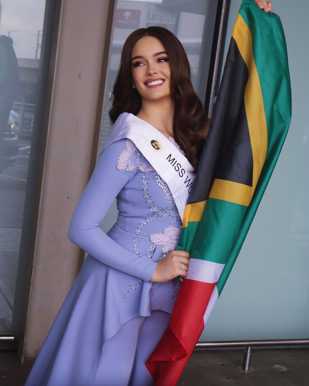 Đại diện Nam Phi - Zoalize Jansen Van Rensburg - mặc trang phục màu tím nữ tính khi ra sân bay. Cô 18 tuổi, có gương mặt ngọt ngào, vóc dáng gợi cảm. Zoalize đang làm giám đốc tiếp thị kỹ thuật số tại quê nhà.