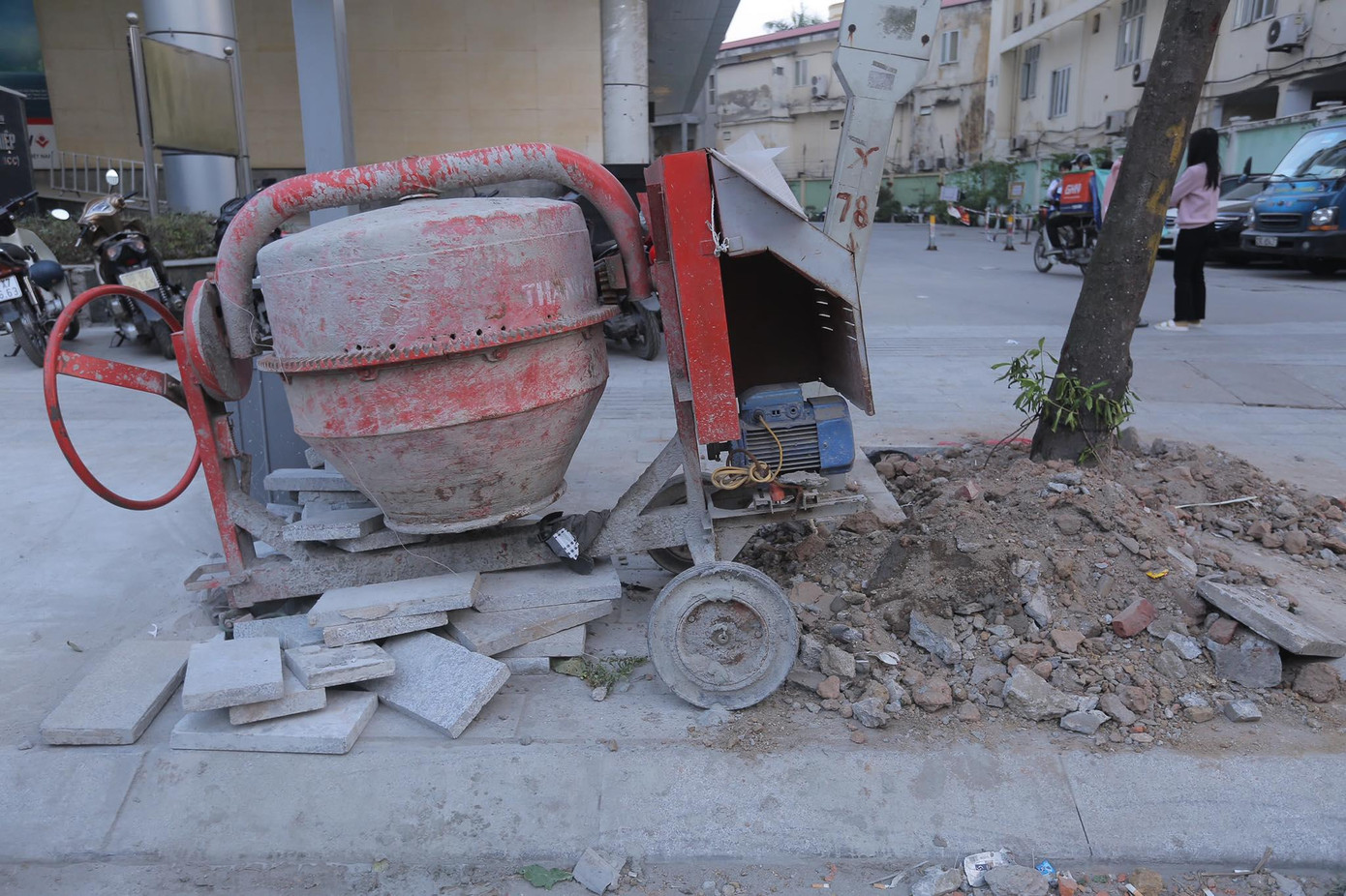 Phương tiện thi công lát vỉa hè, đá lát vỉa hè, đất thải chất đống trên vỉa hè phố Nguyễn Chí Thanh. Ảnh: Duy Phạm