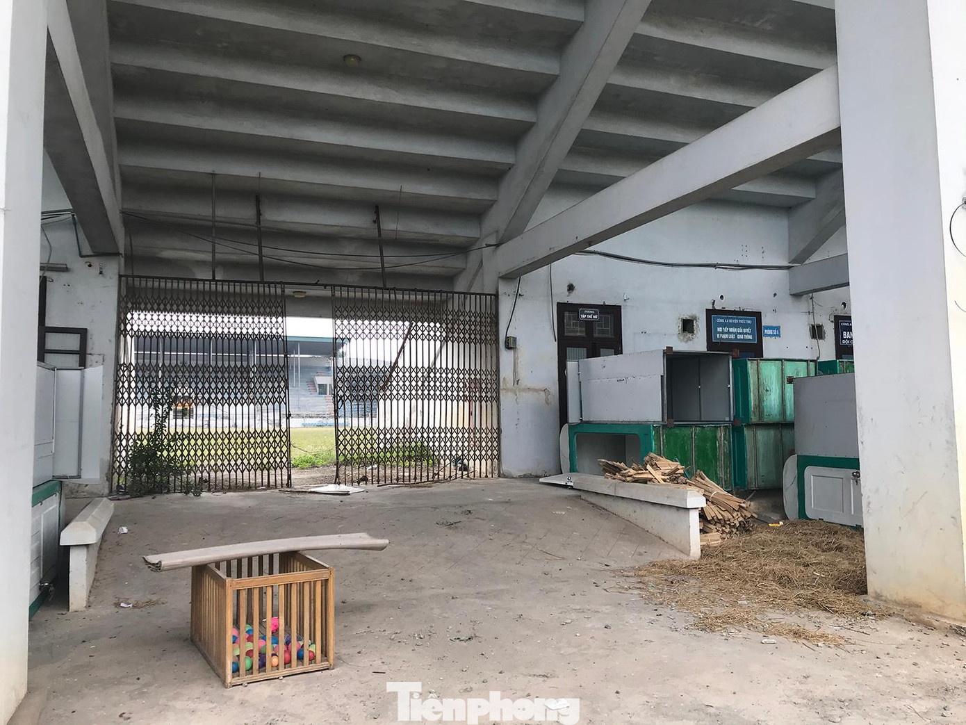 Một chiếc cũi trẻ em đặt trong khuôn viên dưới hầm sân vận động huyện Phúc Thọ. Xung quanh, nhiều vật dụng xếp la liệt. Ảnh: Trường Phong