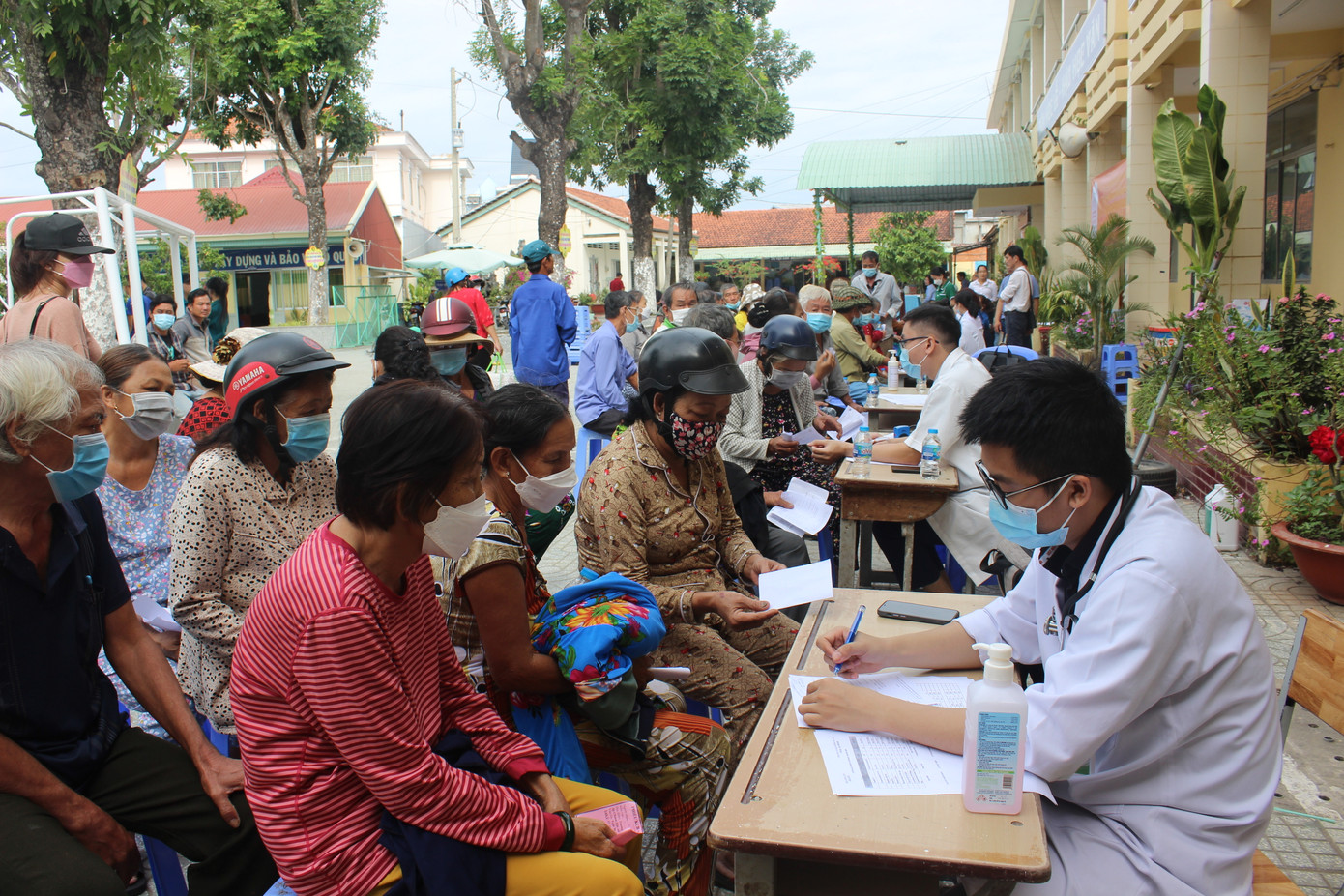 Sau lễ khai mạc, chương trình chính khám bệnh cho bà con được diễn ra. Bà con xếp hàng lần lượt chờ các bác sĩ thăm khám.