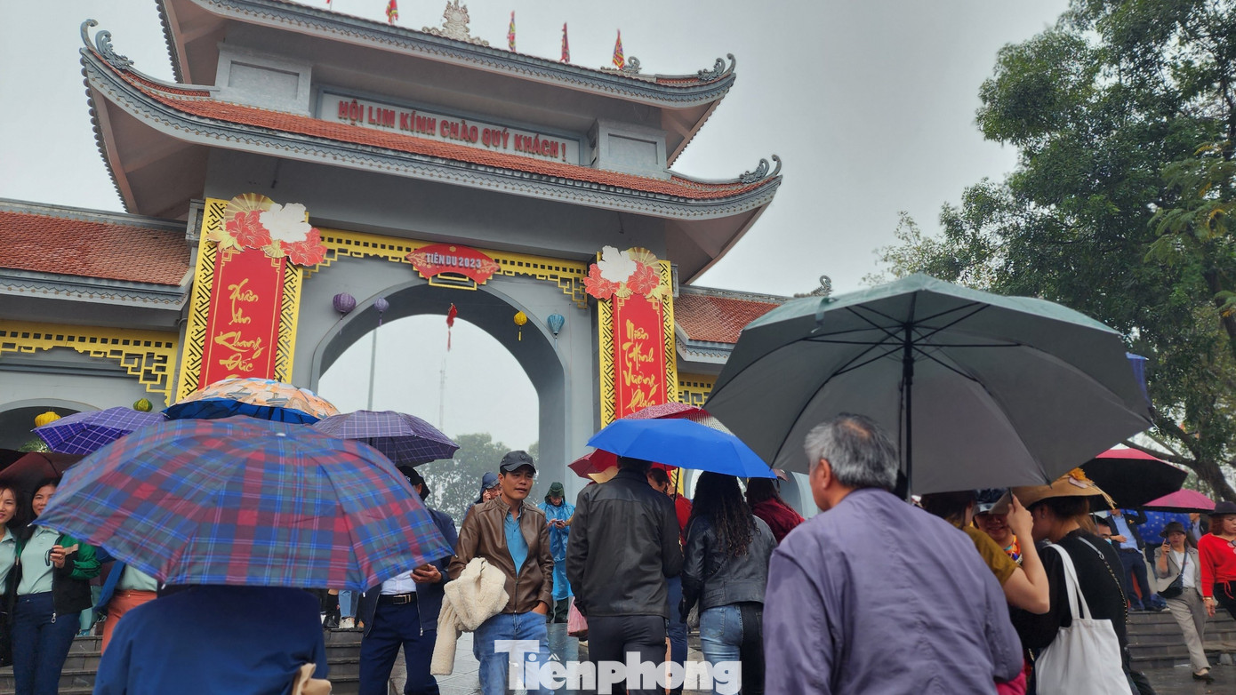Trung tâm lễ hội tọa lạc trên đồi Lim, bao quanh là không gian các làng, xóm và phố chợ bên quốc lộ 1A (xưa là tổng Nội Duệ) nay là thị trấn Lim, các xã Nội Duệ và Liên Bão, huyện Tiên Du. Bất chấp mưa rét, du khách vẫn ùn ùn kéo lên đồi Lim xem hội. Ảnh: TRỌNG QUÂN.