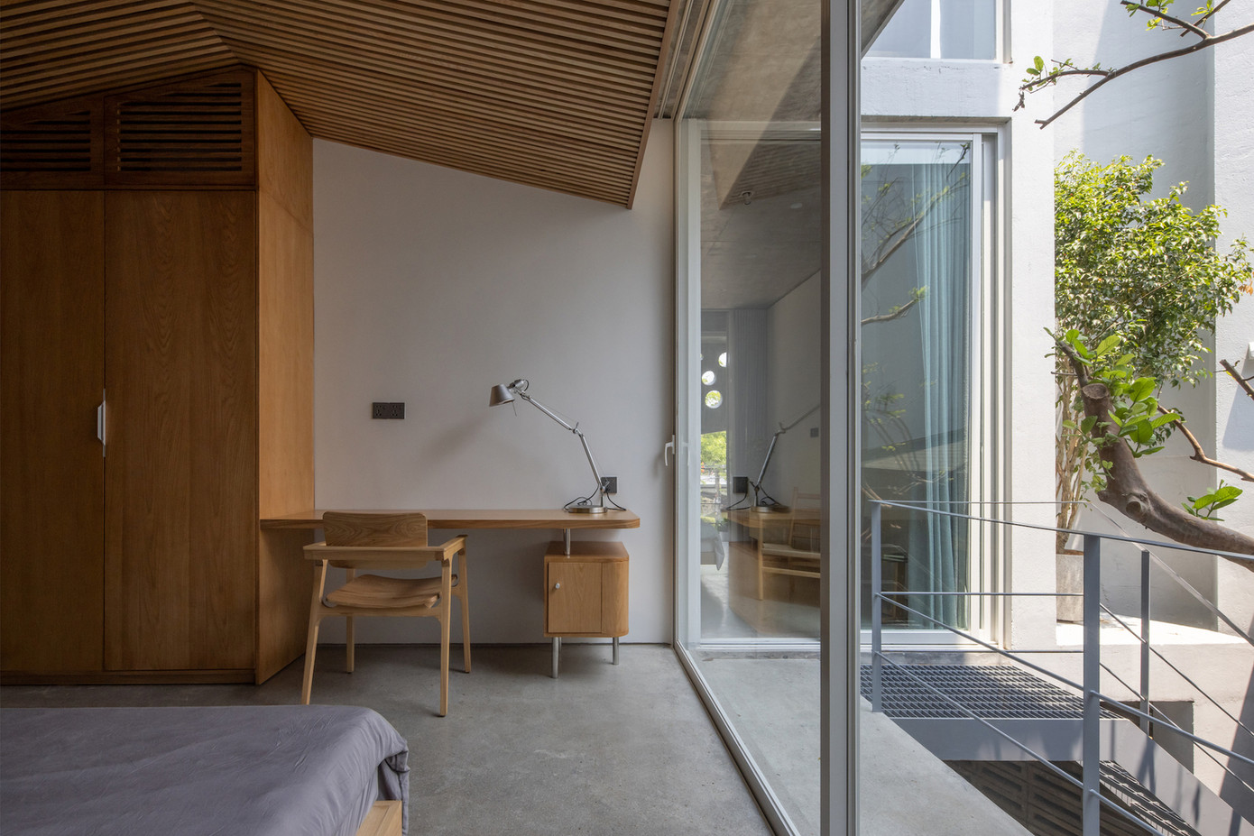 Cửa kính trượt lớn duy trì tầm nhìn thông thoáng, trong khi gỗ tạo ra bầu không khí ấm cúng bên trong, hài hòa với các vật liệu như bê tông và thép hoặc kính.