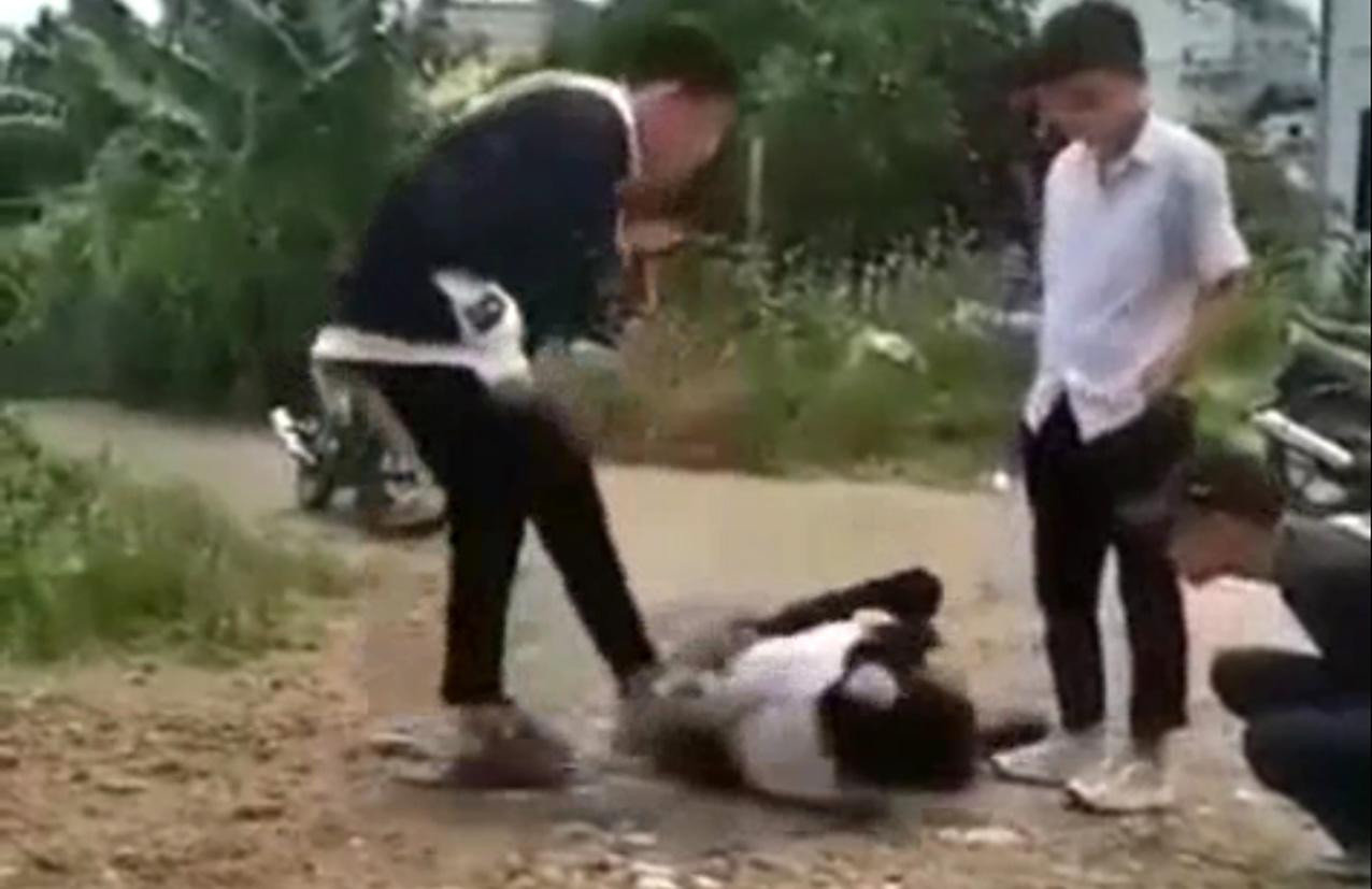 Học sinh lớp 7A7 trường THCS&THPT Tây Sơn bị đánh cách trường hơn 100m. Ảnh cắt từ clip Học sinh lớp 7A7 trường THCS&THPT Tây Sơn bị đánh cách trường hơn 100m. Ảnh cắt từ clip