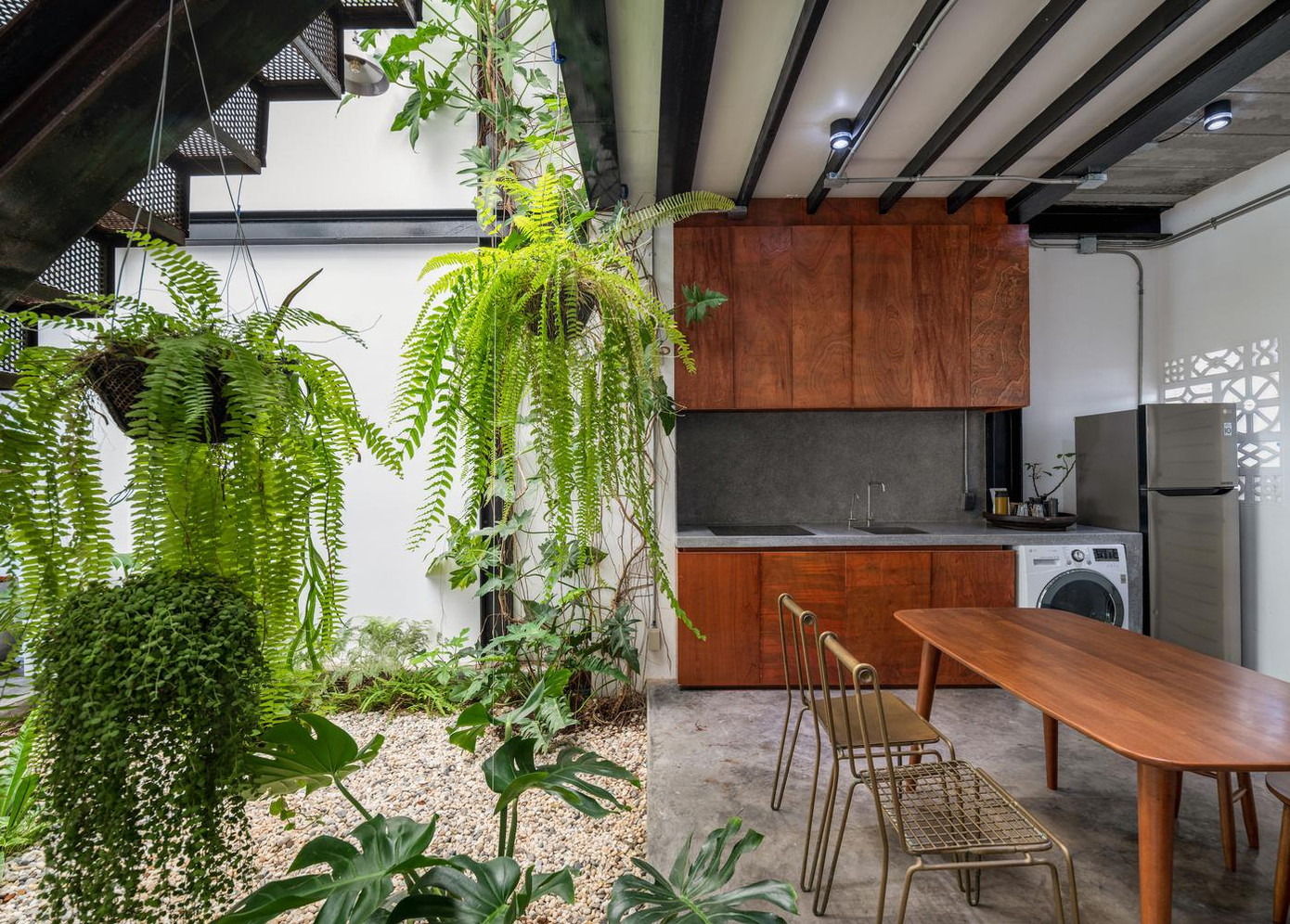 Phòng khách và bếp được ngăn cách với nhau bằng một khu vườn giữa nhà ở bên dưới giếng trời. Phòng khách và bếp được ngăn cách với nhau bằng một khu vườn giữa nhà ở bên dưới giếng trời.