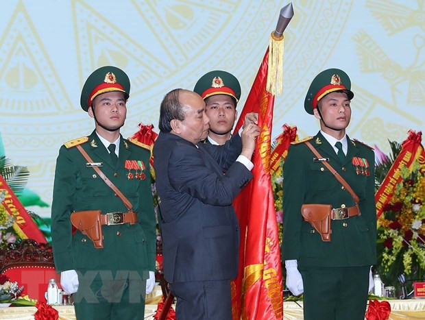 Chủ tịch nước Nguyễn Xuân Phúc gắn Huân chương Lao động hạng Nhất lên Cờ truyền thống của Hội Cựu chiến binh Việt Nam (Ảnh: Trọng Đức/TTXVN).