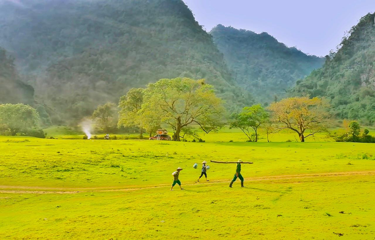 Mùa khô, thung lũng biến thành một thảo nguyên mênh mông, đẹp nên thơ. Trong ảnh là người dân lao động sải bước trên cánh đồng; xa xa là làn khói chiều mờ ảo vẽ lên một bức tranh đẹp đến nao lòng.