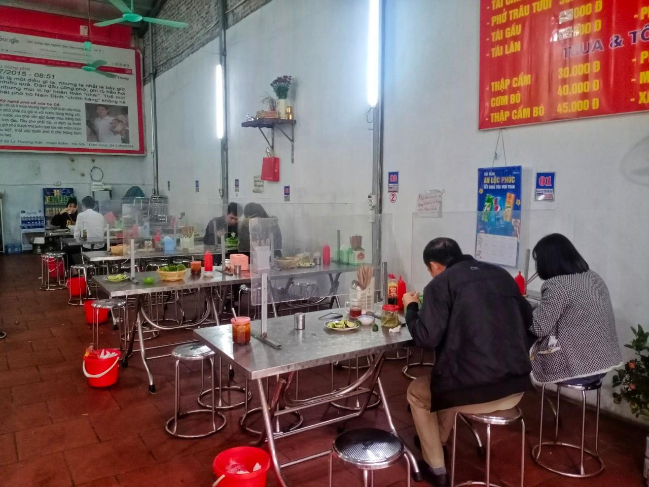 Các bàn ăn của quán anh được kê đúng khoảng cách an toàn phòng dịch và được lắp thêm tấm chắn, an toàn phòng dịch cho khách. Các bàn ăn của quán anh được kê đúng khoảng cách an toàn phòng dịch và được lắp thêm tấm chắn, an toàn phòng dịch cho khách.