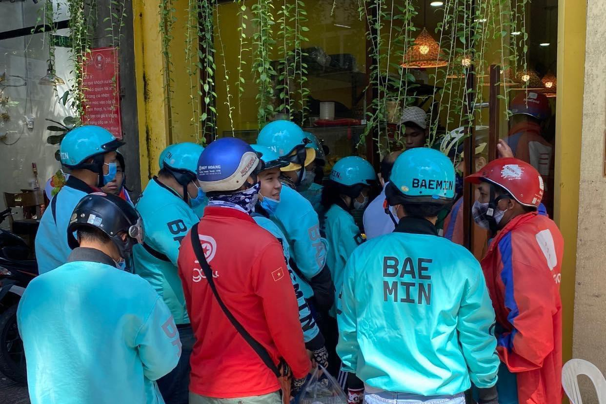 Việc không giữ khoảng cách an toàn tối thiểu khi nhận món khiến các shipper gặp nhiều rủi ro về lây nhiễm chéo trong mùa dịch. Ảnh: Minh Đăng.