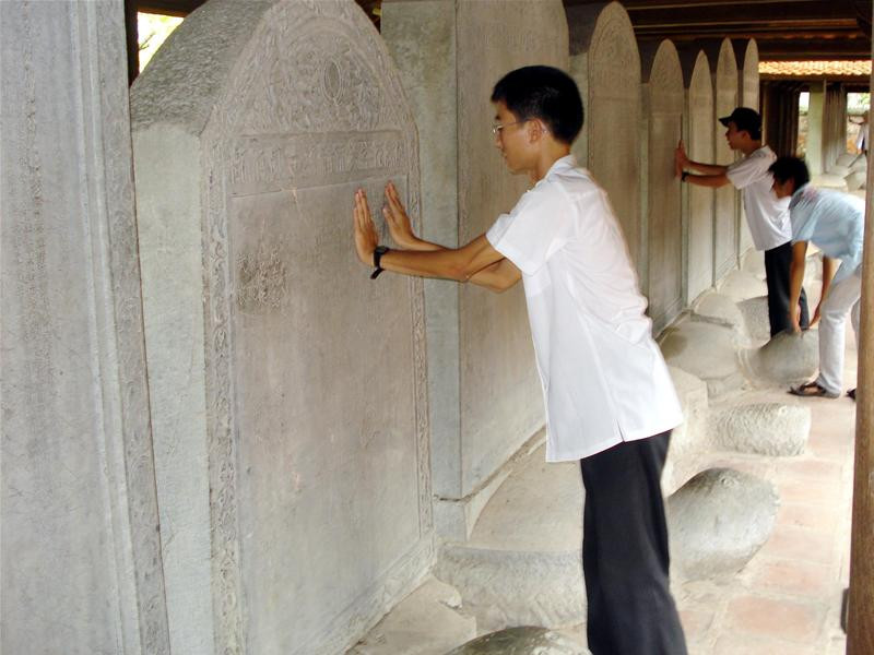 Để cả tiền lên đầu rùa để cầu mong thi tốt Phải sờ thế này mới yên tâm được