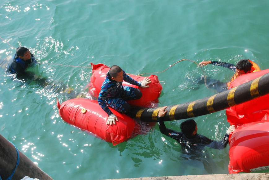 Tiếp theo là dùng phao đôi để nâng cáp. Công việc này do những thợ lặn Việt Nam và Indonesia thực hiện, họ trực tiếp bơi trên mặt biển để đặt từng chiếc phao vào sợi cáp đang thả dần xuống